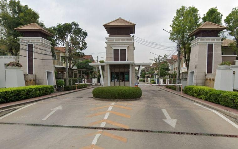 Bangkok suburban housing estate — moo baan compound with residential houses and greenery