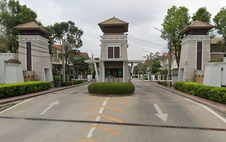 Bangkok suburban housing estate — moo baan compound with residential houses and greenery